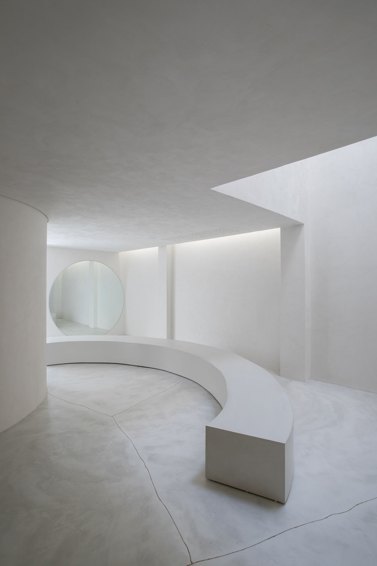 Selo Store by MNMA studio — MNMA studio's retail interior demonstrates controlled geometric intervention within a monochromatic concrete envelope.