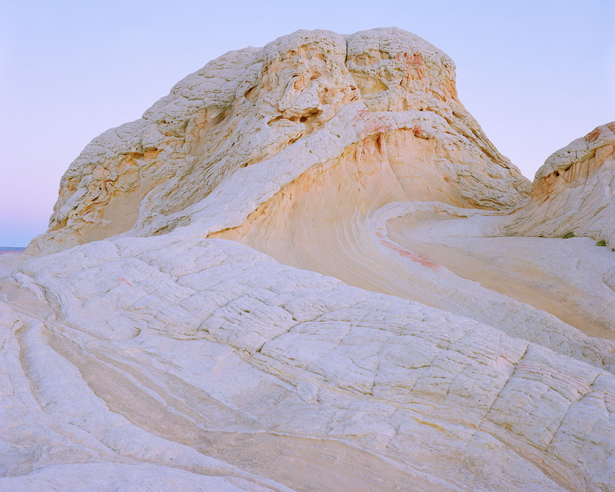 Breathtaking Landscapes by Luca Tombolini — Eroded limestone or chalk formations dominate the composition, their surfaces carved by geological time into sweeping diagonal striations and parallel ridge...