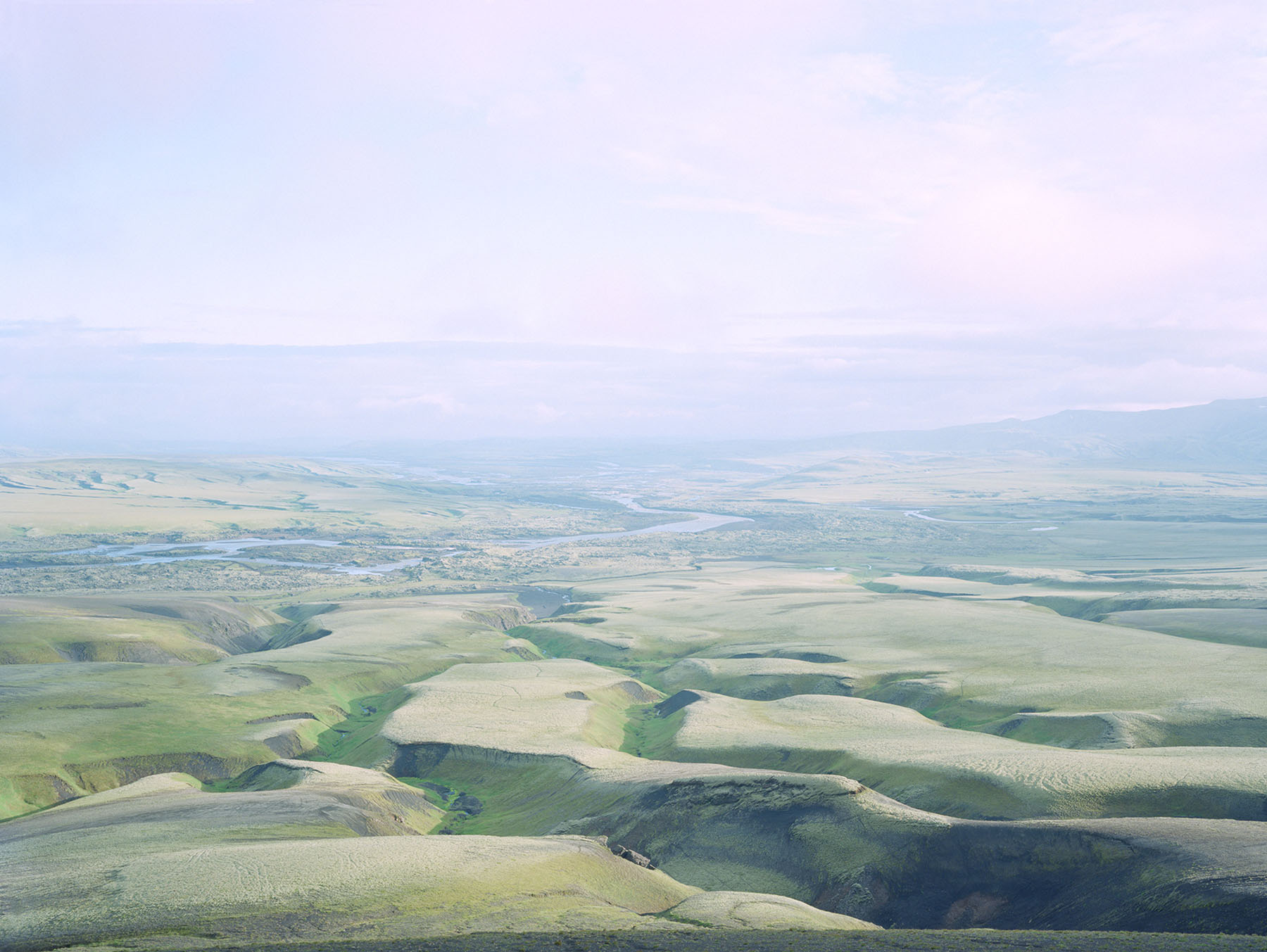 Breathtaking Landscapes by Luca Tombolini — Aerial view of a vast subarctic plateau revealing parallel ridge formations with sharp angular striations running diagonally across the composition.