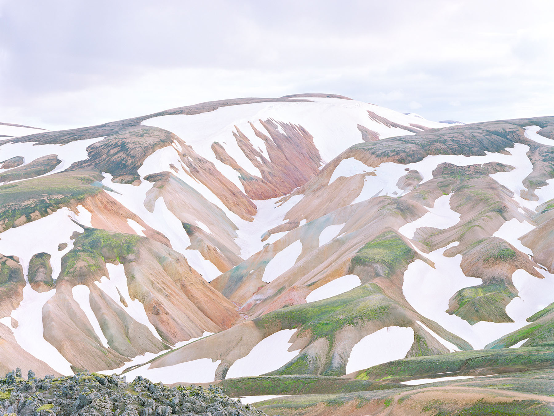 Breathtaking Landscapes by Luca Tombolini — Rhyolite ridge formations dominate this high-altitude landscape, their parallel striations angled diagonally across the mountainside in sharp, geometric relief.