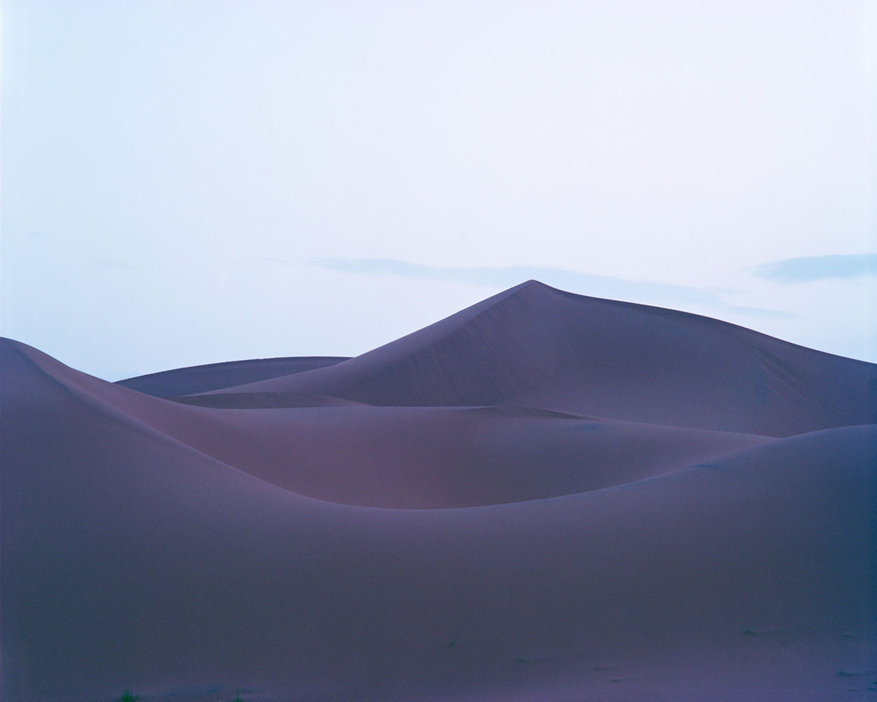 Breathtaking Landscapes by Luca Tombolini — Undulating sand dunes with parallel ridge formations create a rhythmic composition across the frame.