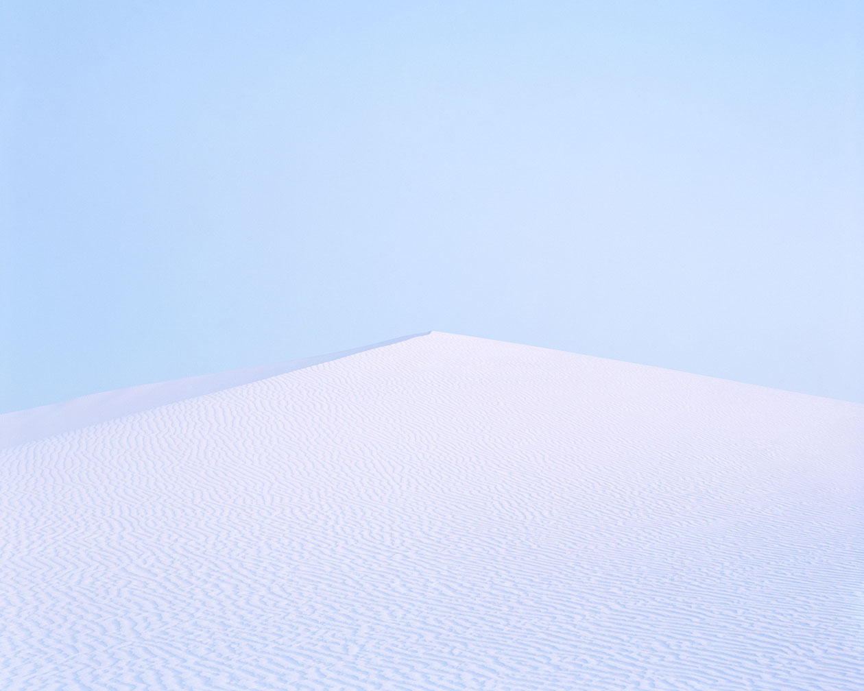 Breathtaking Landscapes by Luca Tombolini — A solitary sand dune rises against a clear blue sky in this large-format landscape photograph.