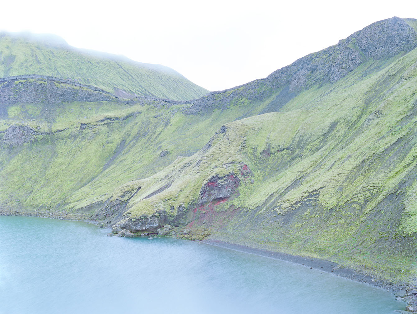 Breathtaking Landscapes by Luca Tombolini — A glacial lake of vivid turquoise sits nestled within a U-shaped valley carved by ancient ice.
