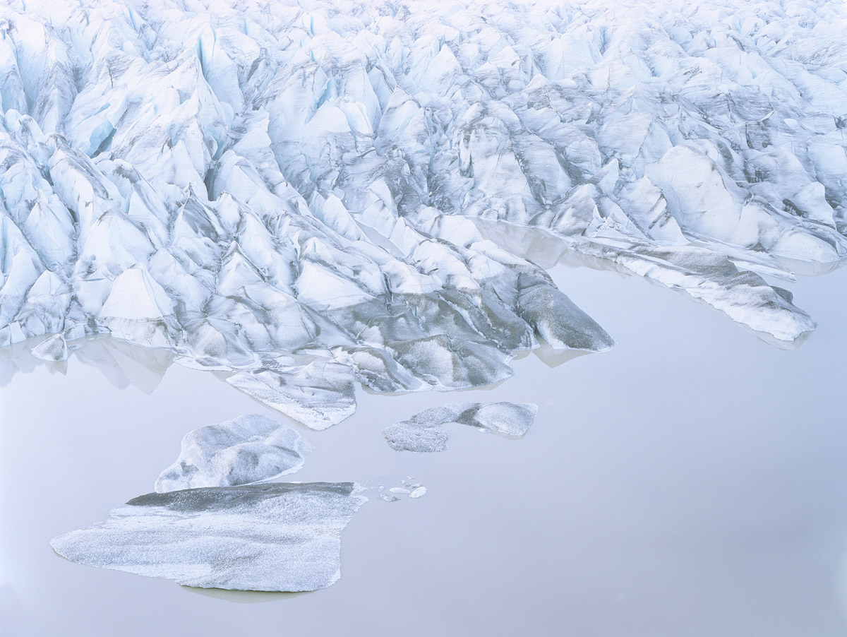 Breathtaking Landscapes by Luca Tombolini — Aerial photograph of a glacier's heavily crevassed surface, captured at close range to emphasize the dramatic topography of fractured ice.