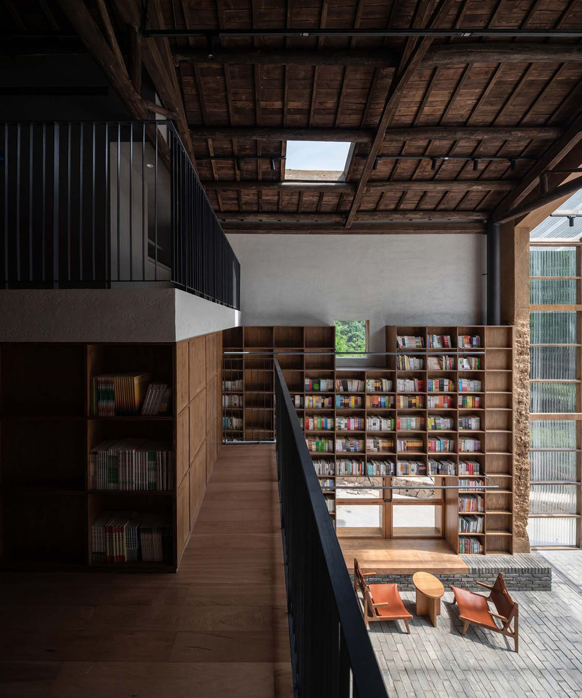 Capsule Hotel and Bookstore in Village Qinglongwu by Atelier tao+c — Interior view of the repurposed village structure showcasing the spatial strategy for combining accommodation and public program.