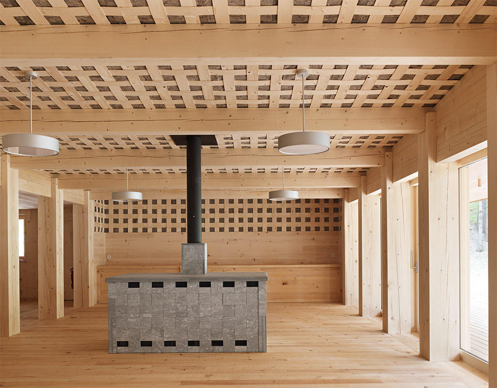 Tegia da vaut forest hut by Gion A. Caminada — Interior view of the forest hut revealing the structural and spatial organization.