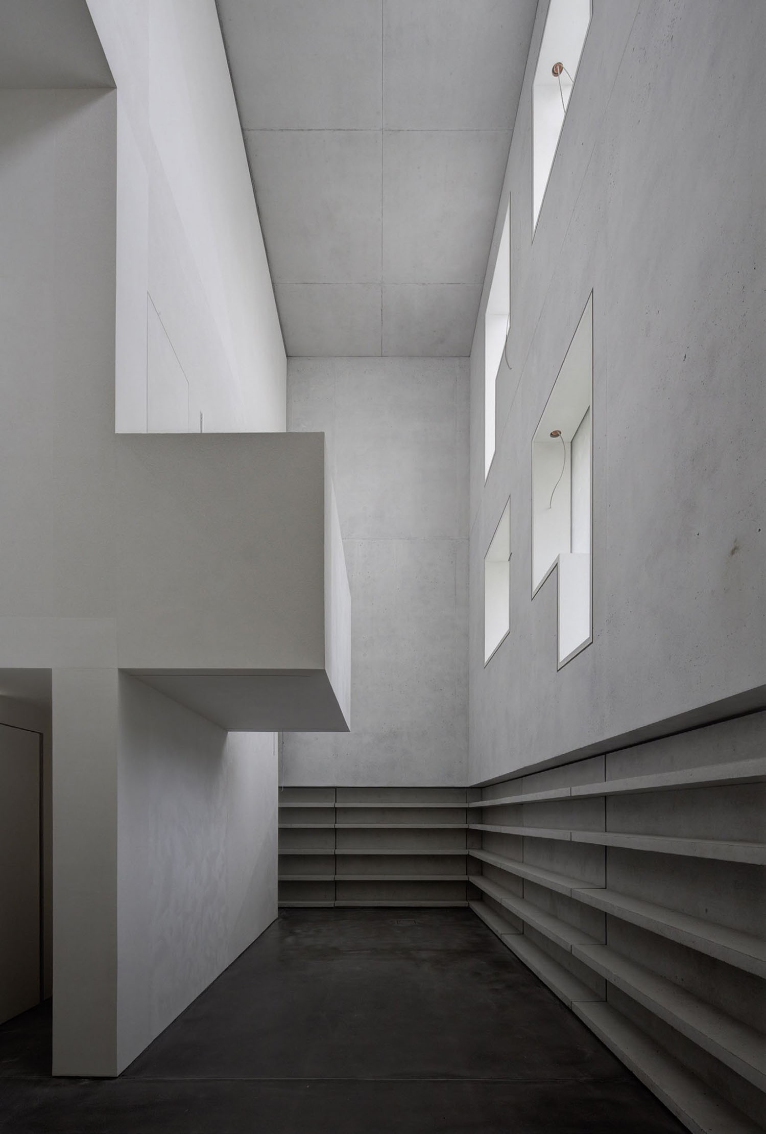Neue Meisterhäuser Bauhaus Dessau by Bruno Fioretti Marquez — A monolithic concrete interior space demonstrates material continuity between walls, ceiling, and floor.