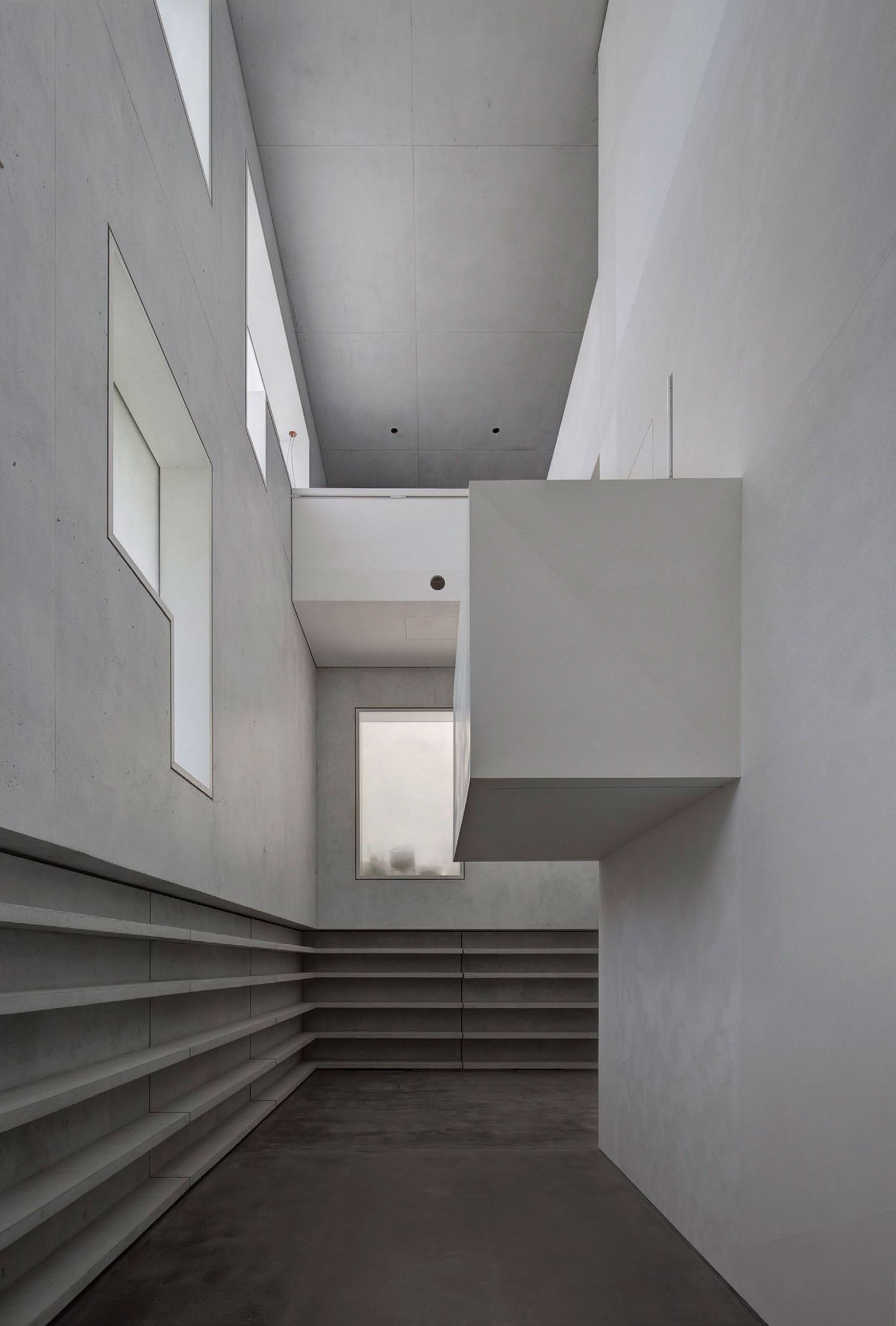 Neue Meisterhäuser Bauhaus Dessau by Bruno Fioretti Marquez — A monolithic concrete interior passage reveals the hybrid reconstruction approach through layered spatial complexity.