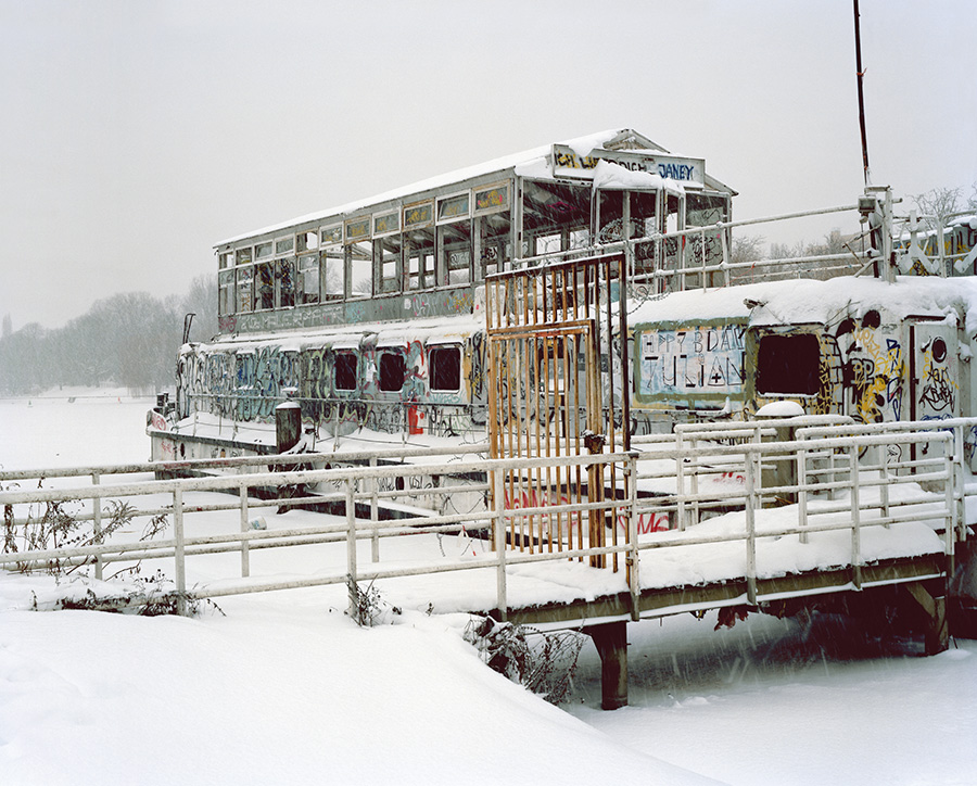 Aftermath by Jörn Vanhöfen — A snow-covered riverbank reveals the detritus of recreational infrastructure abandoned to winter.