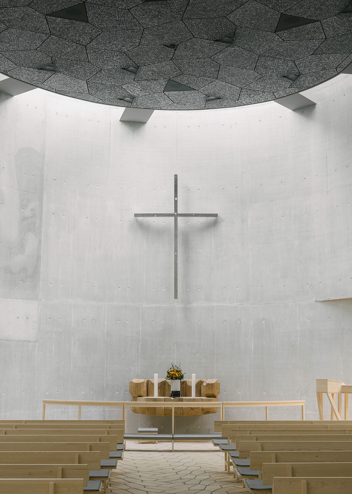 Trekroner Church by Rørbæk and Møller — Interior view of Trekroner Church looking toward the altar, emphasizing the geometric purity of brutalist design.