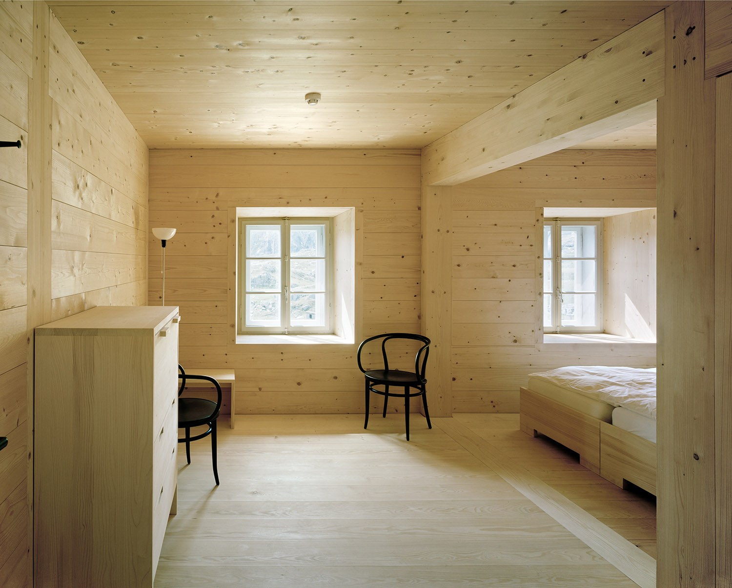 Old hospice, St. Gotthard Pass by Miller & Maranta — Interior of a timber-lined bedroom featuring walls and ceiling of knotty pine, horizontal board construction throughout.
