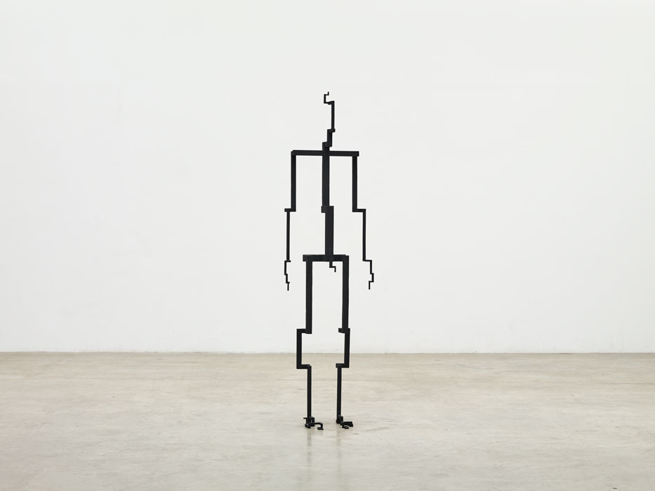 Sculptures by Antony Gormley — A timber figure constructed from stacked rectangular blocks in varying sizes, assembled to suggest human proportions.