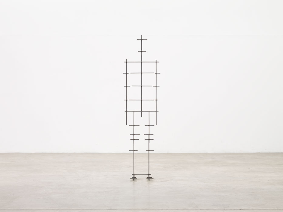 Sculptures by Antony Gormley — A vertical timber sculpture constructed from stacked rectangular blocks of varying dimensions, assembled to approximate human proportions.