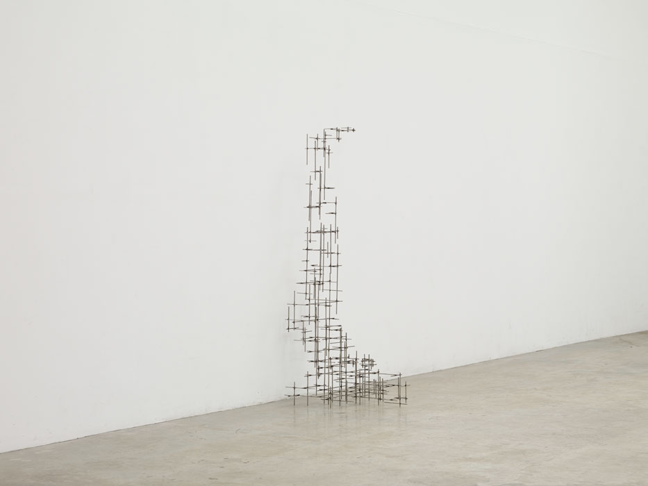 Sculptures by Antony Gormley — A timber construction assembled from rectangular blocks of varying dimensions stacks vertically to approximate human form.