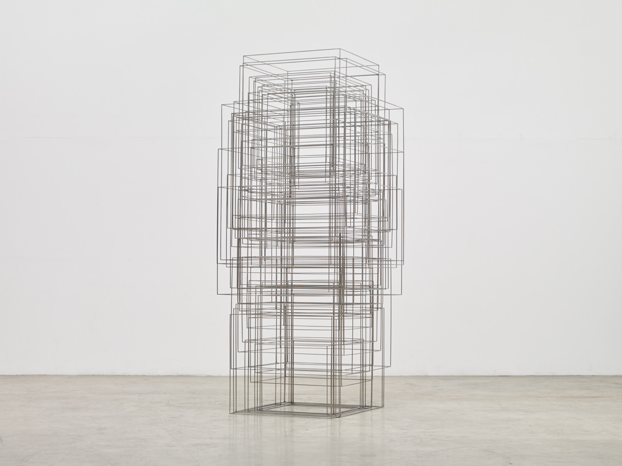 Sculptures by Antony Gormley — A wireframe sculpture constructed from steel linear elements arranged in stacked rectangular forms that progressively diminish in scale toward the top,...