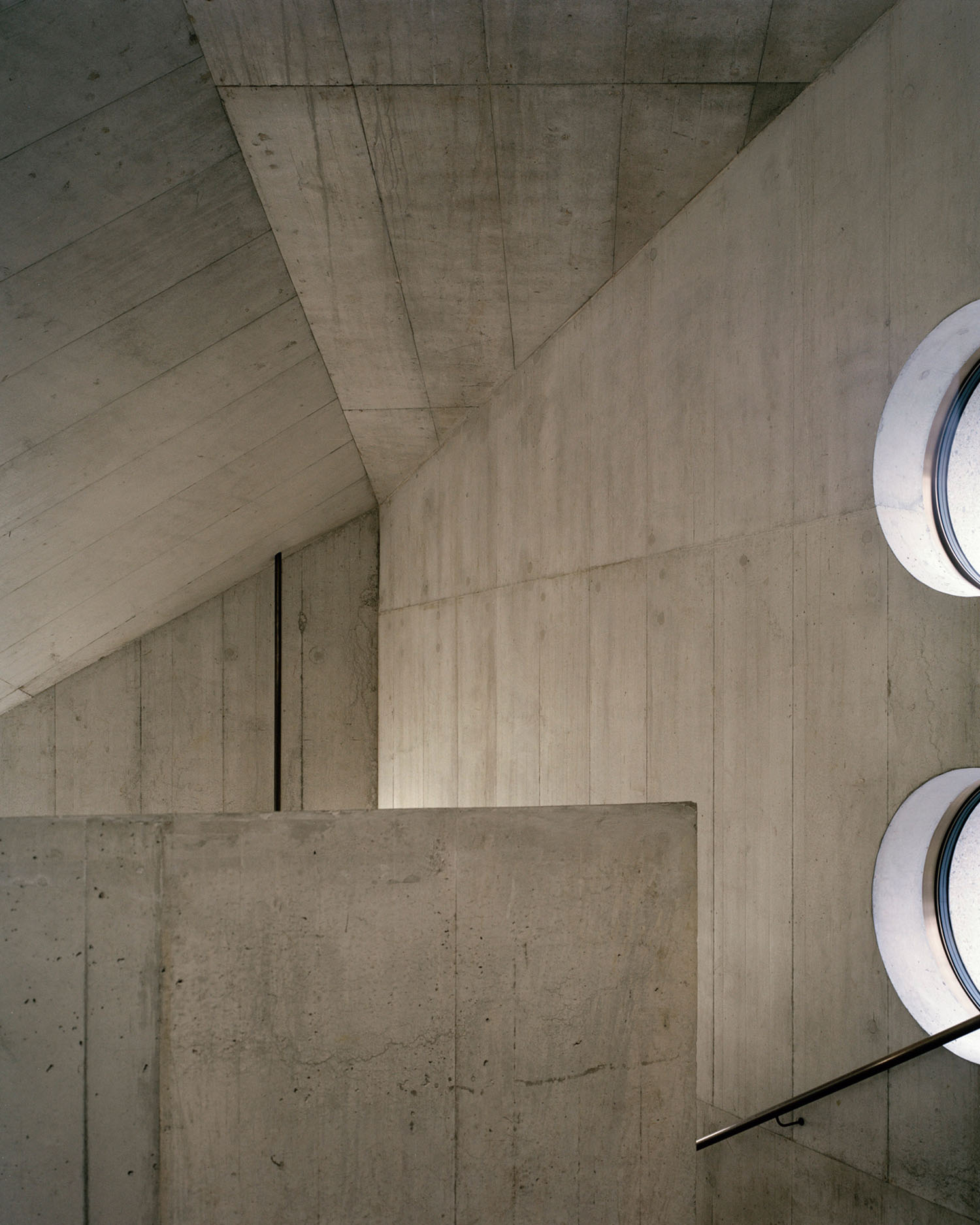 Swiss National Museum by Christ & Gantenbein photographed by Rory Gardiner — Overhead view of the Swiss National Museum's new wing interior reveals the building's structural logic: board-formed concrete ceiling panels aligned with...