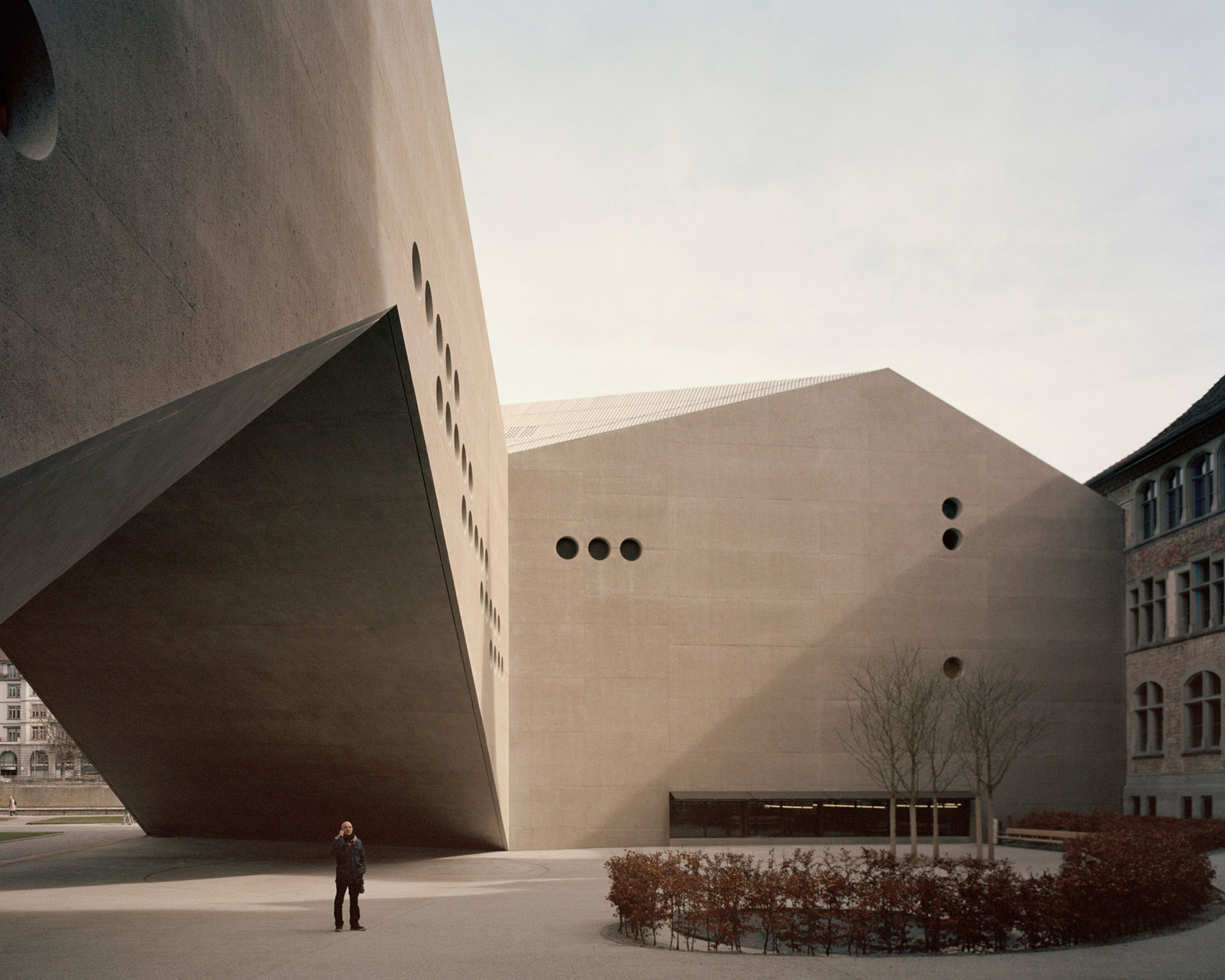 Swiss National Museum by Christ & Gantenbein photographed by Rory Gardiner — A low-angle photograph captures the monolithic concrete volume of Christ & Gantenbein's museum extension, its cream-colored facade dominating the frame.