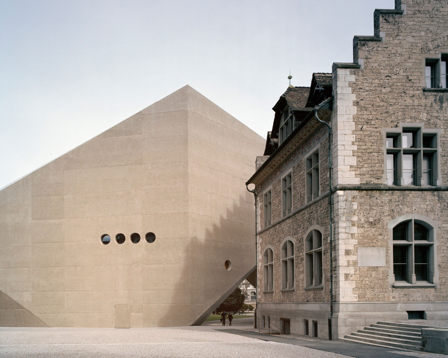 Swiss National Museum by Christ & Gantenbein photographed by Rory Gardiner — Christ & Gantenbein's new wing for the Swiss National Museum presents a cream-colored concrete facade punctuated by four circular perforations arranged in a...