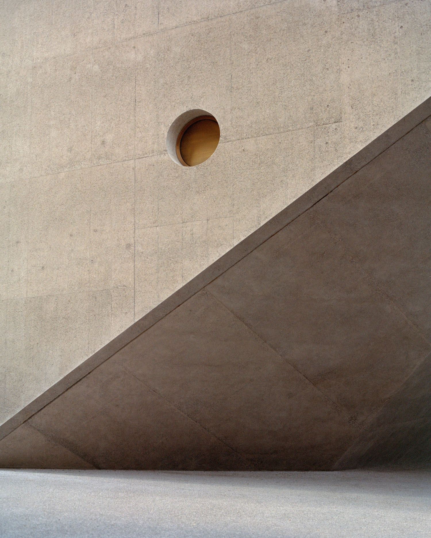 Swiss National Museum by Christ & Gantenbein photographed by Rory Gardiner — A low-angle view isolates the junction between Christ & Gantenbein's new concrete wing and the adjacent historic masonry structure.