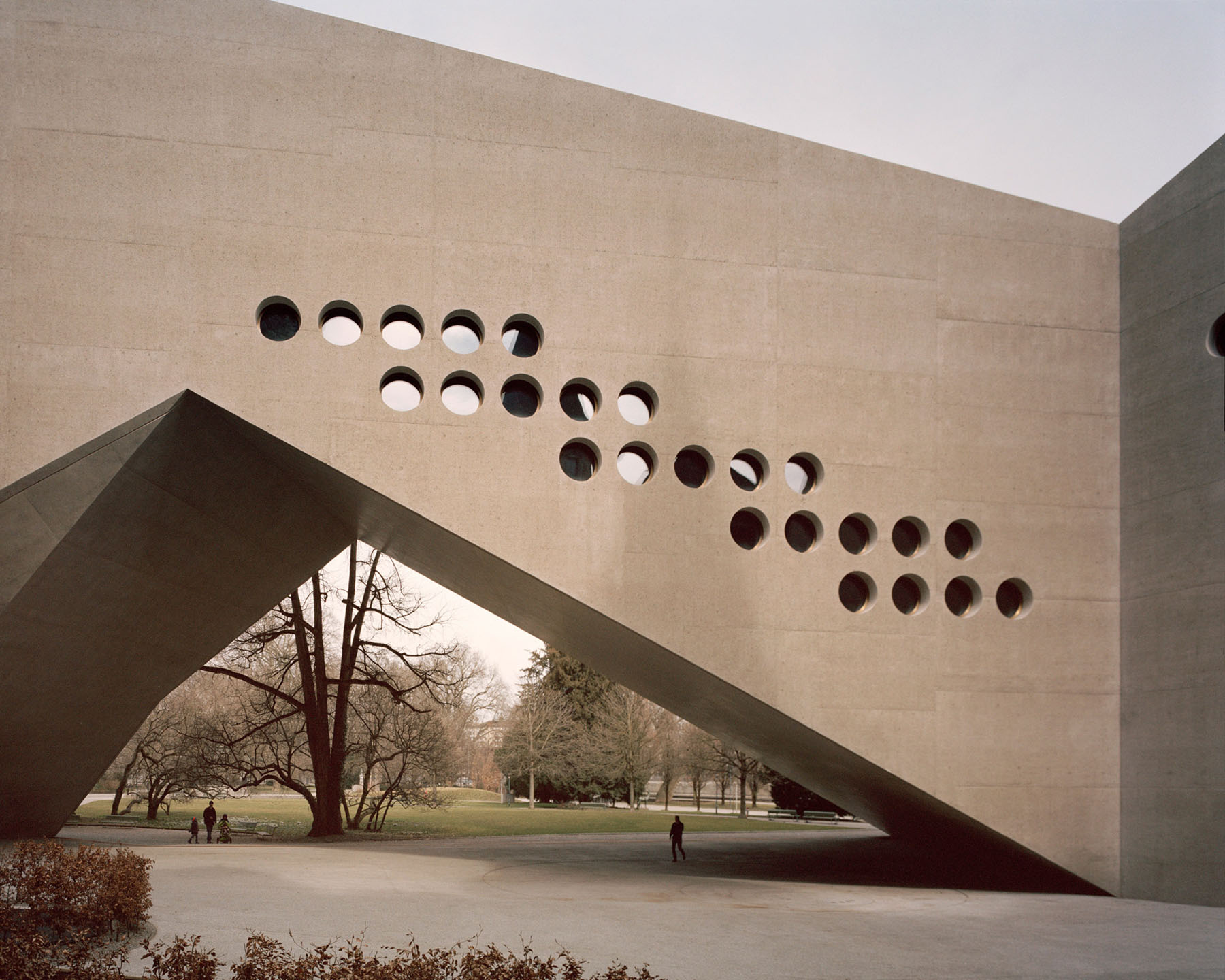 Swiss National Museum by Christ & Gantenbein photographed by Rory Gardiner — Christ & Gantenbein's concrete extension to the Swiss National Museum presents a monolithic facade punctuated by a grid of circular perforations arranged in...