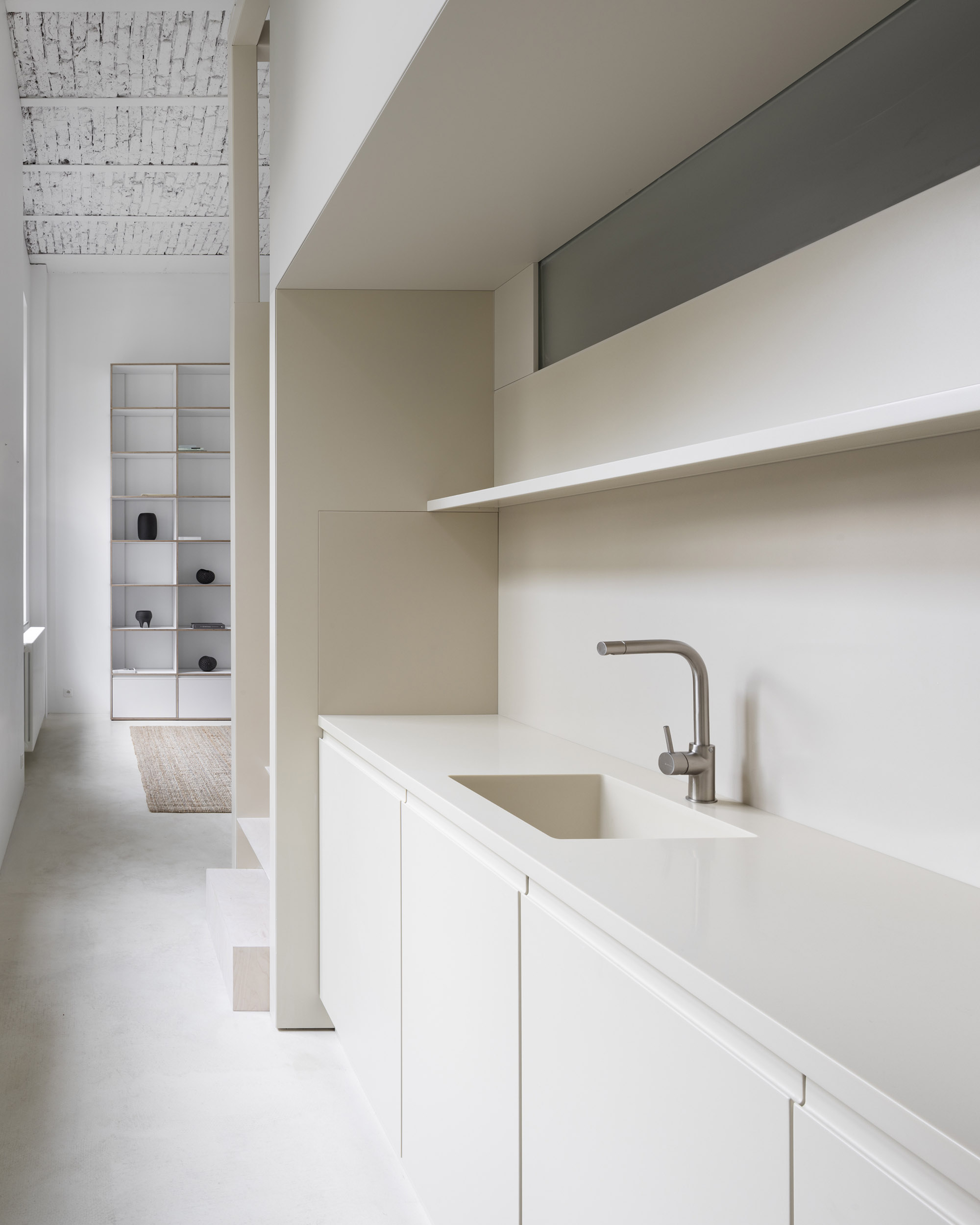 A-PLACE K907 by Thisispaper Studio — A galley kitchen occupies the compressed lower passage beneath the 4.75-meter ceiling of the converted 1903 Print House.
