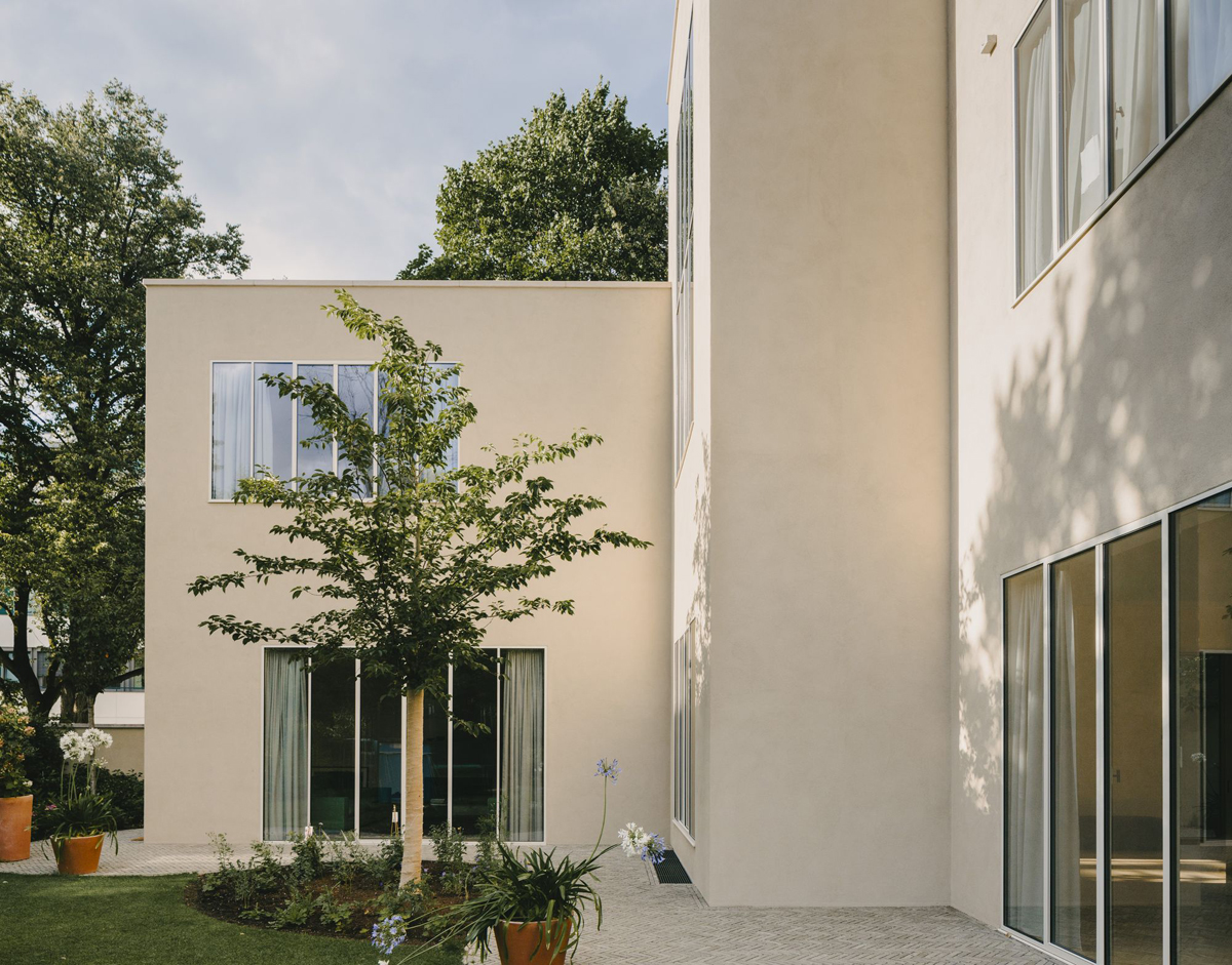 Bogenhausen House by David Chipperfield Architects — The rear garden facade presents a studied composition of geometric volumes and material restraint.