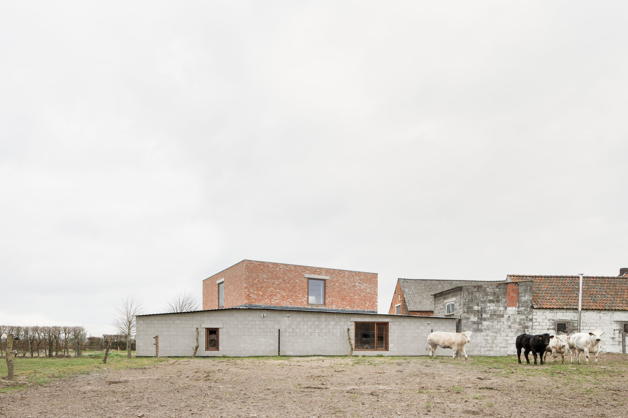 Studio SDS by GRAUX & BAEYENS — The new studio volume presents a stark contrast to the surrounding vernacular farm buildings.