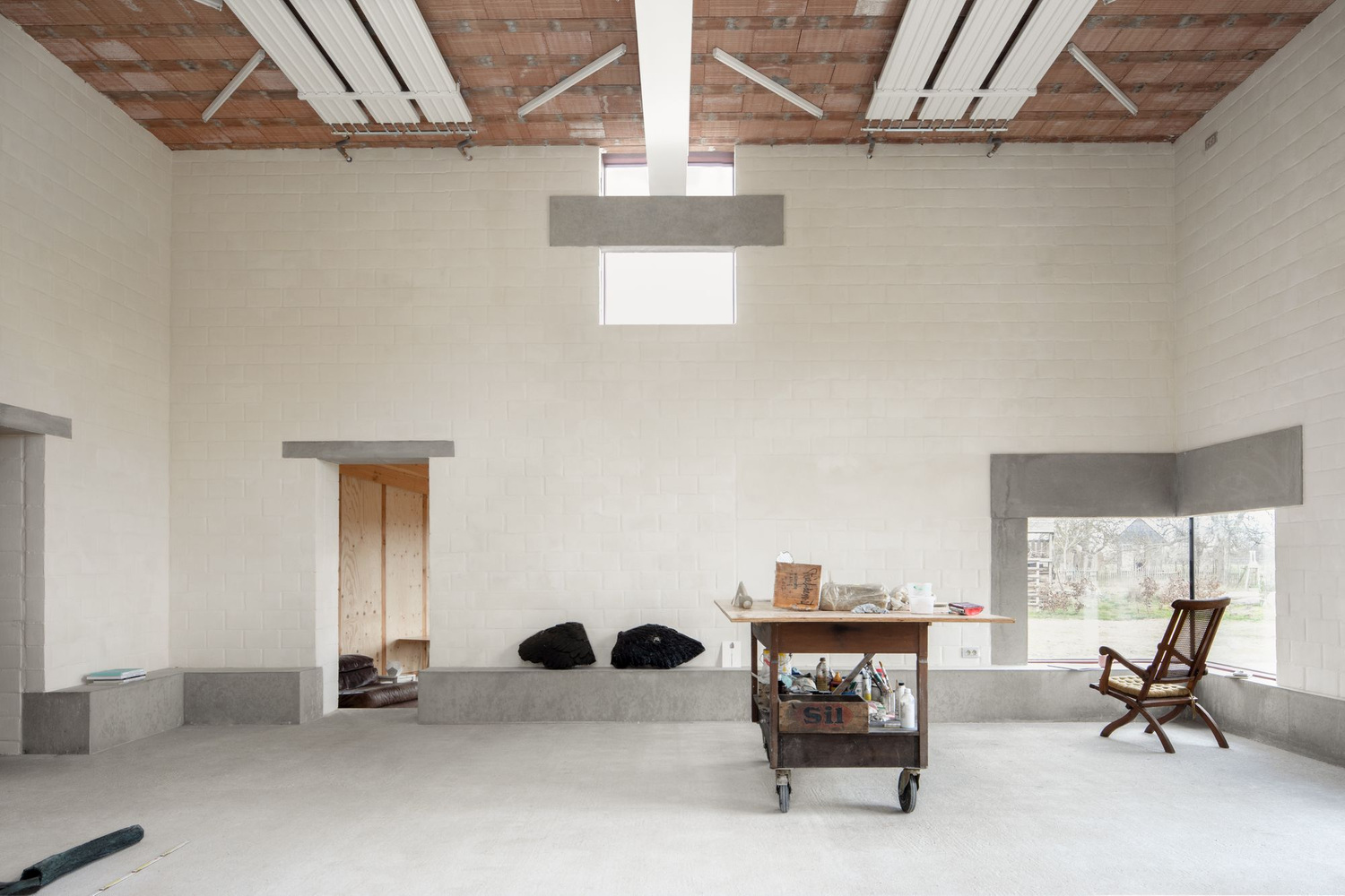 Studio SDS by GRAUX & BAEYENS — A double-height studio interior captured from an elevated vantage point, revealing the spatial generosity designed for large-scale sculpture.