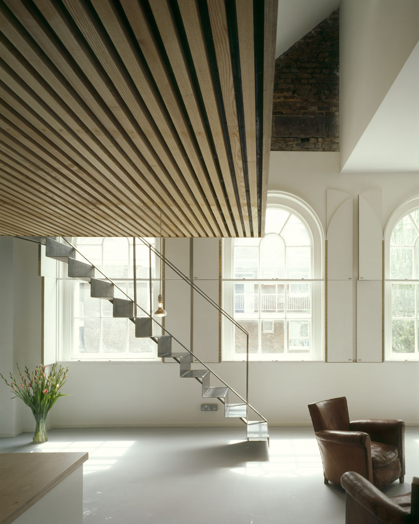 Bavaria Road Studio by West Architecture — The Bavaria Road Studio's double-height interior is defined by a rhythmic timber-slat ceiling that spans the full width of the space, its parallel lines...