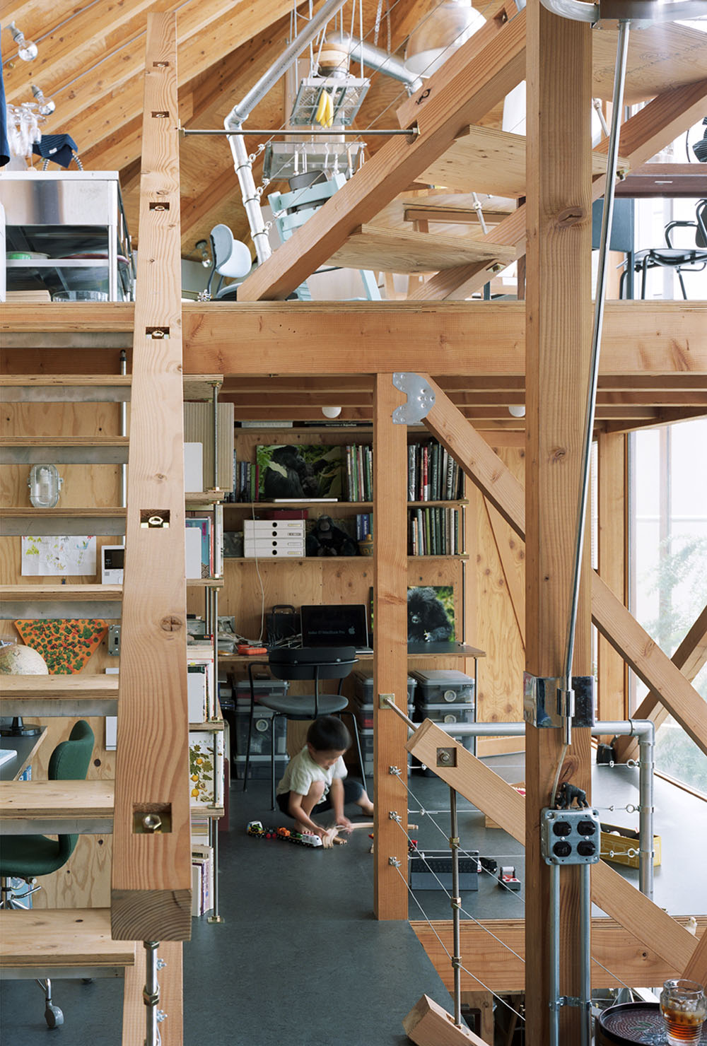 Daita2019 House by Suzuko Yamada Architects — A multi-level timber-frame interior reveals the structural skeleton of the Daita2019 House, with substantial pine posts and cross-bracing dominating the...