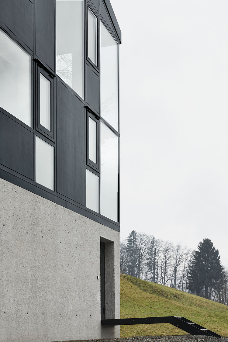 House Hohlen by Jochen Specht — House Hohlen's upper facade dominates the frame in a low-angle composition that emphasizes the pitched gable roof against an overcast sky.