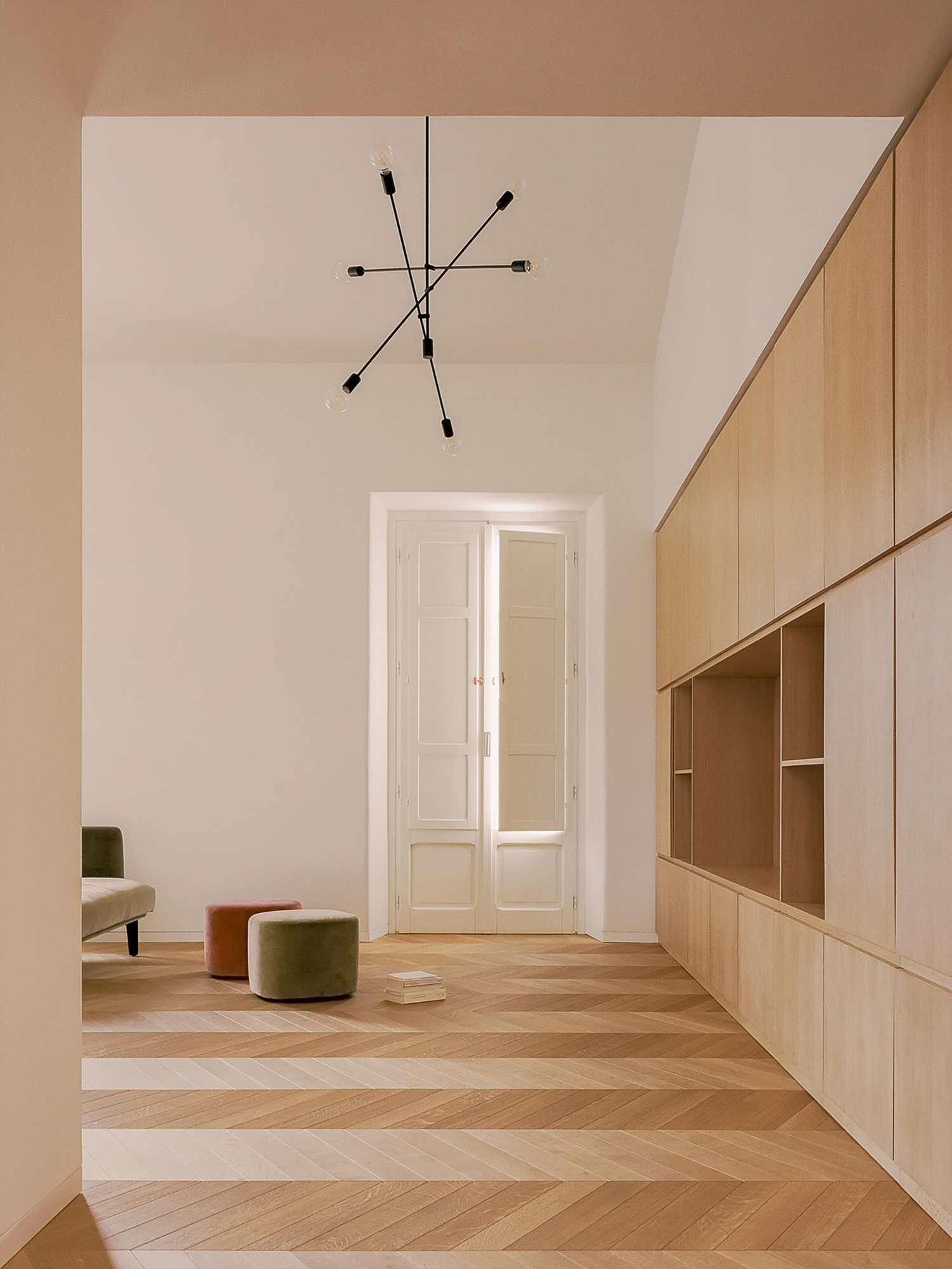 House for a Couple by SET Architects — A hallway in the renovated Fondi apartment demonstrates the project's spatial strategy through open-plan design.