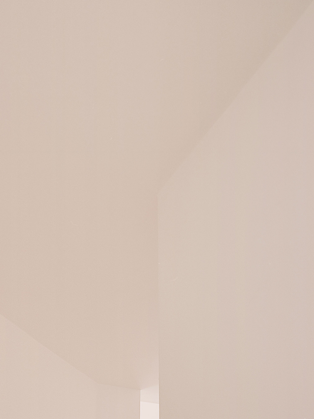House for a Couple by SET Architects — A threshold moment captured in cool, neutral tones.