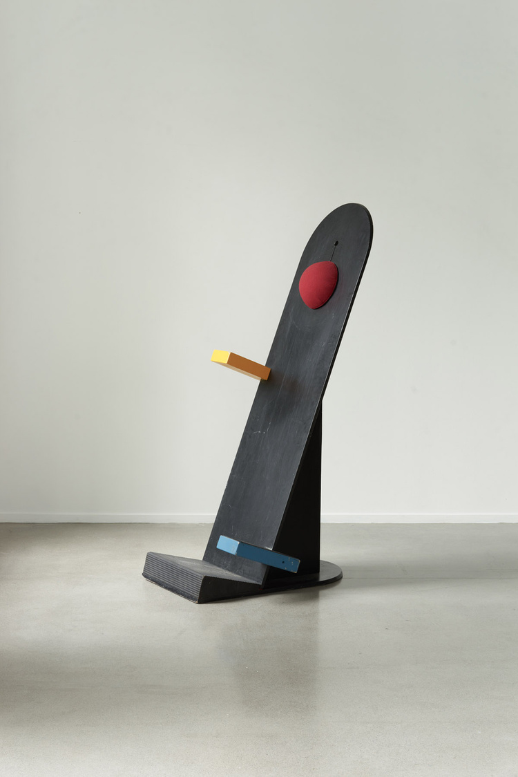 Unika Auction by Bjørn van den Berg and Falke Svatun — A sculptural wooden object tilts at a pronounced angle on a curved black base.