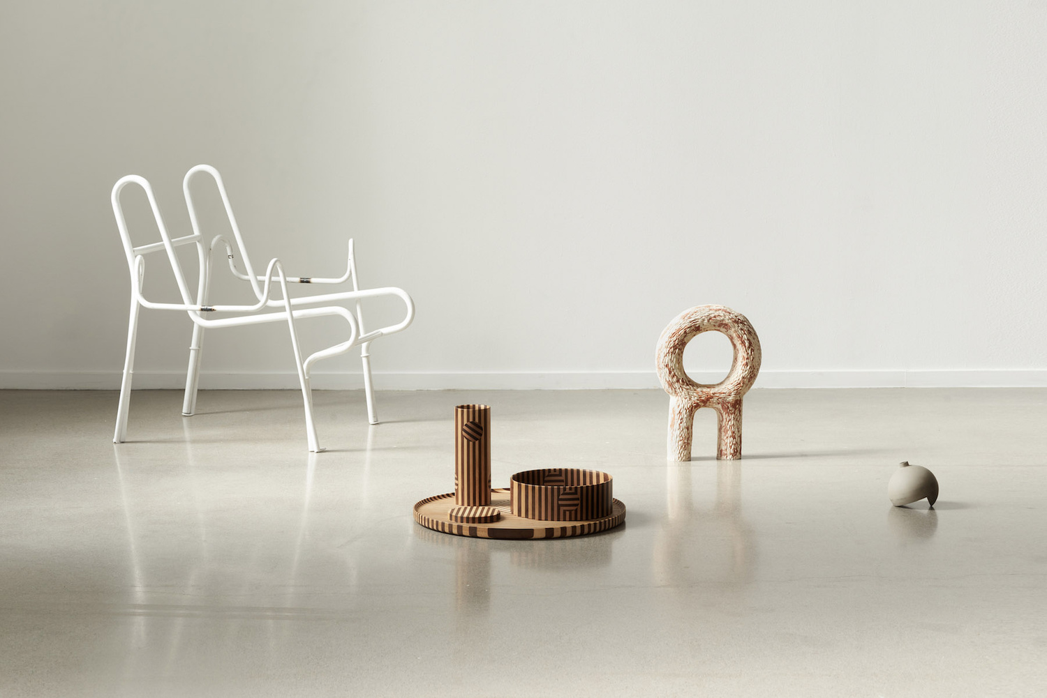 Unika Auction by Bjørn van den Berg and Falke Svatun — A curated arrangement of contemporary Norwegian design objects displayed on polished concrete.