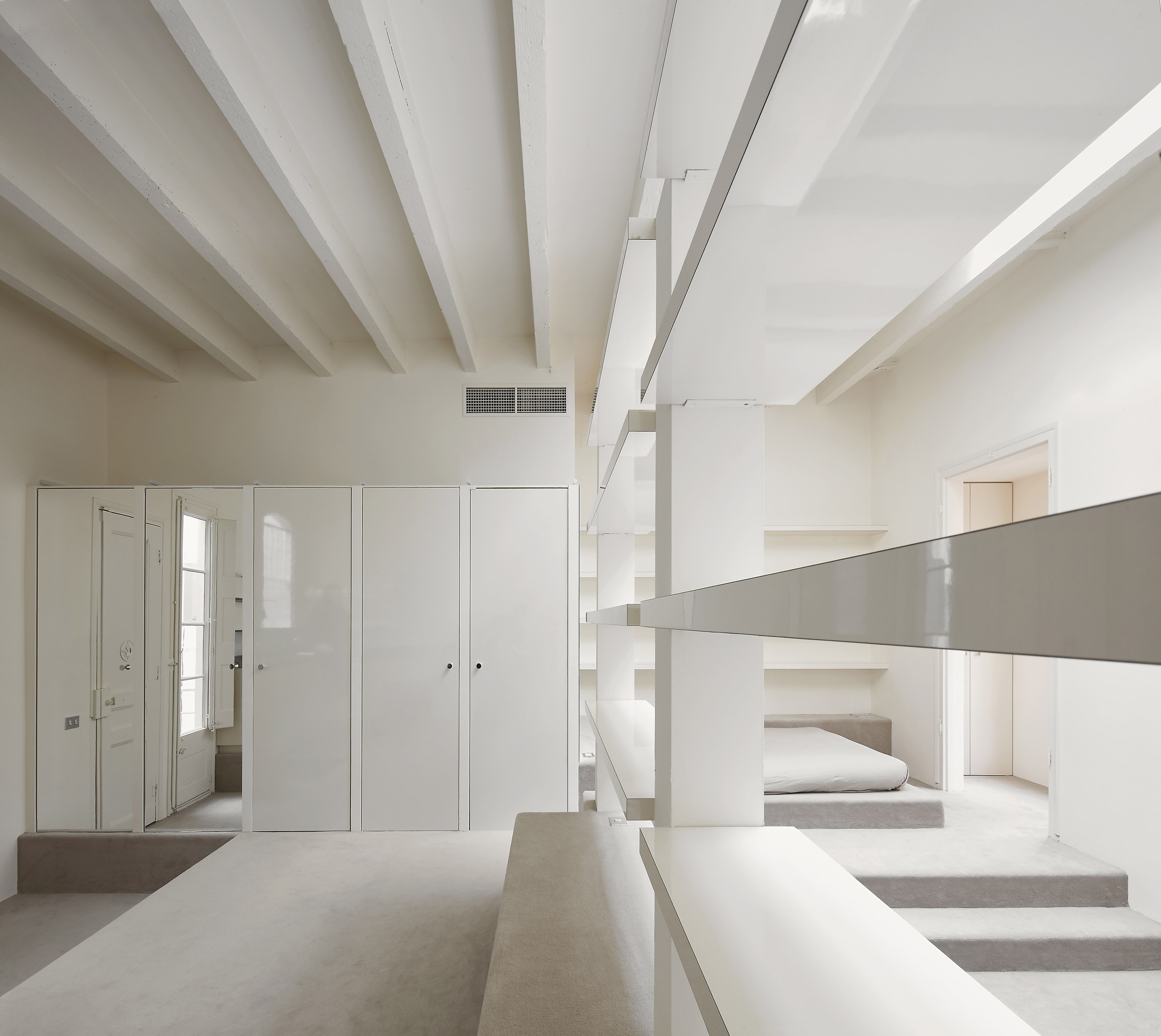 Barcelona Apartment Renovation by Arquitectura-G — A stepped interior reveals the full height of the Barcelona apartment's lofty 3.9-metre ceiling.