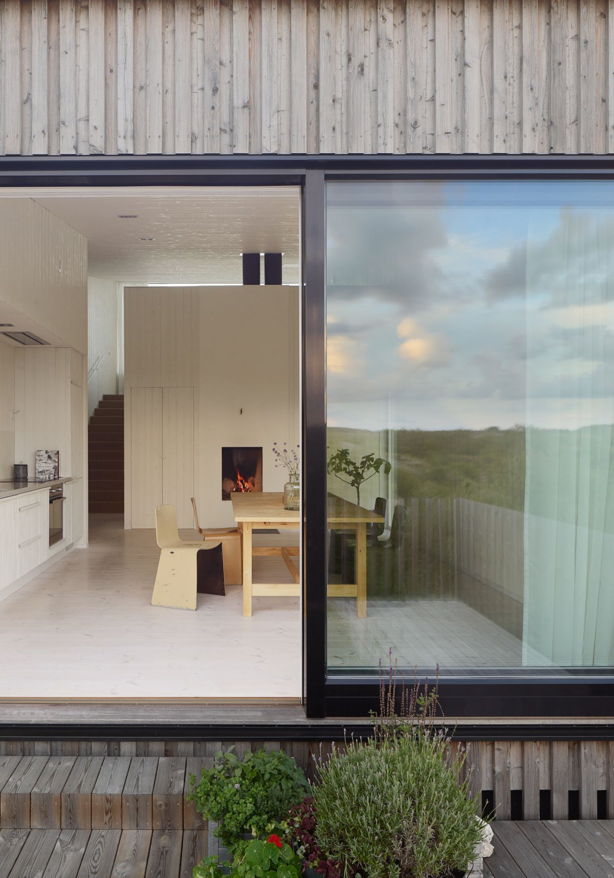 Kyrkesund Weekend House by Mattias Gunneflo — The Kyrkesund Weekend House presents itself as a horizontal gesture of transparency and warmth against the Swedish landscape.