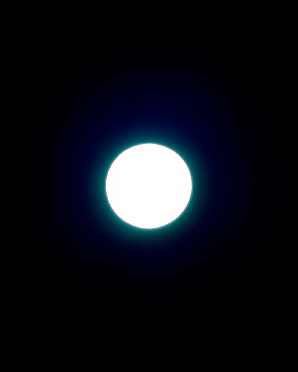 The Circle and the Line by Erik Östensson — A luminous sphere dominates the composition against absolute black, its white core emitting a cyan-tinted glow that creates a halo effect around the...