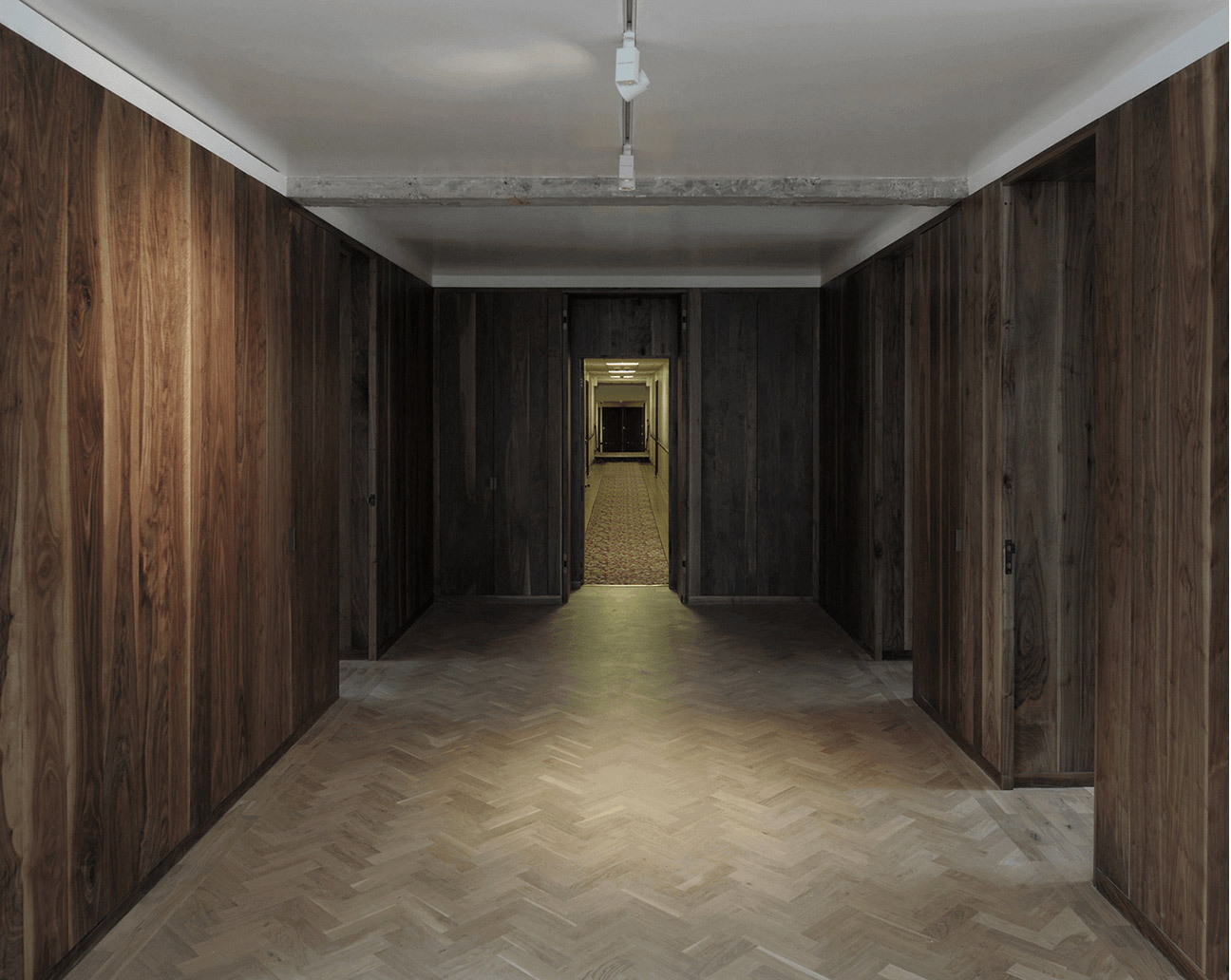 Queens Court by Feilden Fowles — A corridor in Queens Court demonstrates the systematic rationalization of the 1930s apartment through integrated storage solutions.