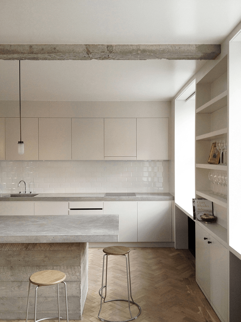 Queens Court by Feilden Fowles — The kitchen interior of Queens Court demonstrates a restrained material palette organized along a clear axial perspective.