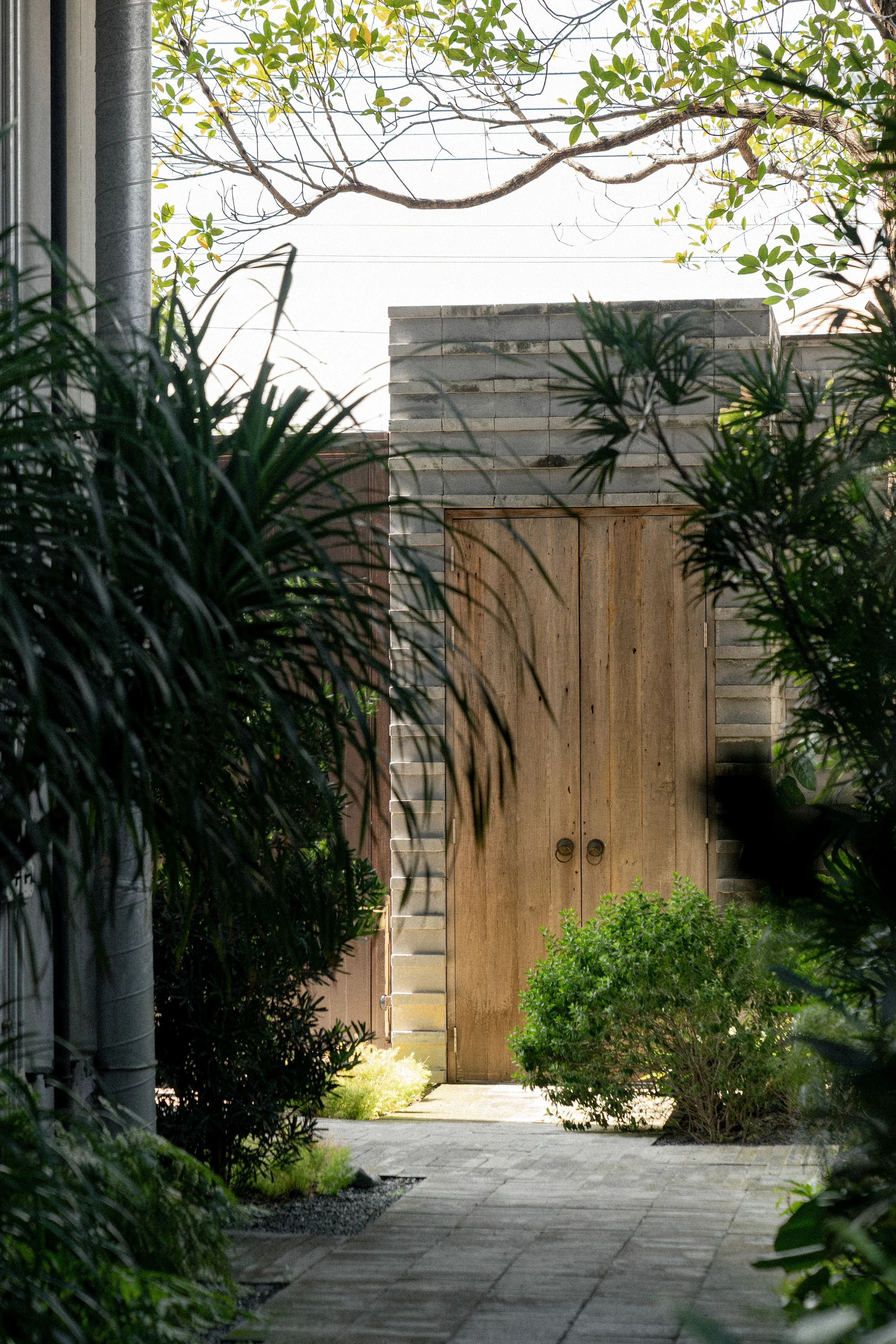 H168 House by Only Human, Bangkok Thailand, Chinese spatial traditions, dark grey brick, courtyard, moon gate