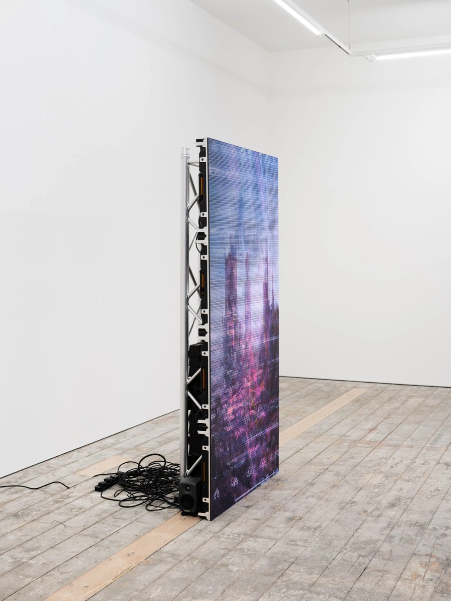Clone Repo (server ruin) by Chris Dorland at Nicoletti Contemporary — A vertical LED panel displays heavily pixelated and corrupted digital imagery, the composition dominated by electric blue and magenta scan-line artifacts...