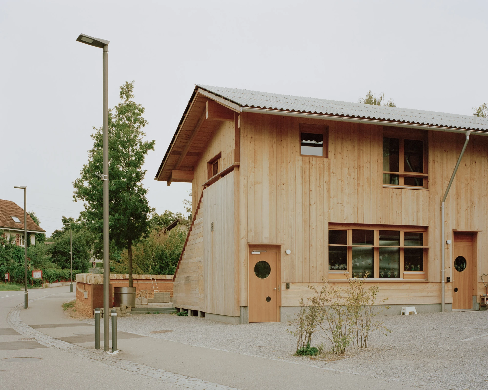House in Deitingen by studio ou — Studio ou's residential building in Deitingen employs a typological strategy that responds directly to the village's agricultural context.