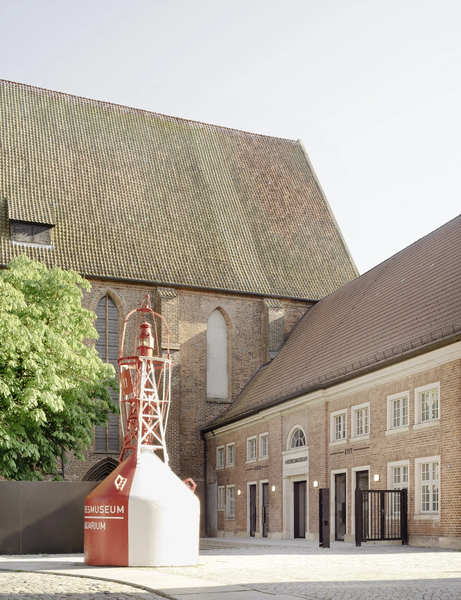 Renovation and Extension of MEERESMUSEUM by Reichel Schlaier Architekten — The courtyard elevation of the renovated Katharinenkloster reveals the layered temporal palimpsest of Stralsund's UNESCO-listed Hanseatic complex.