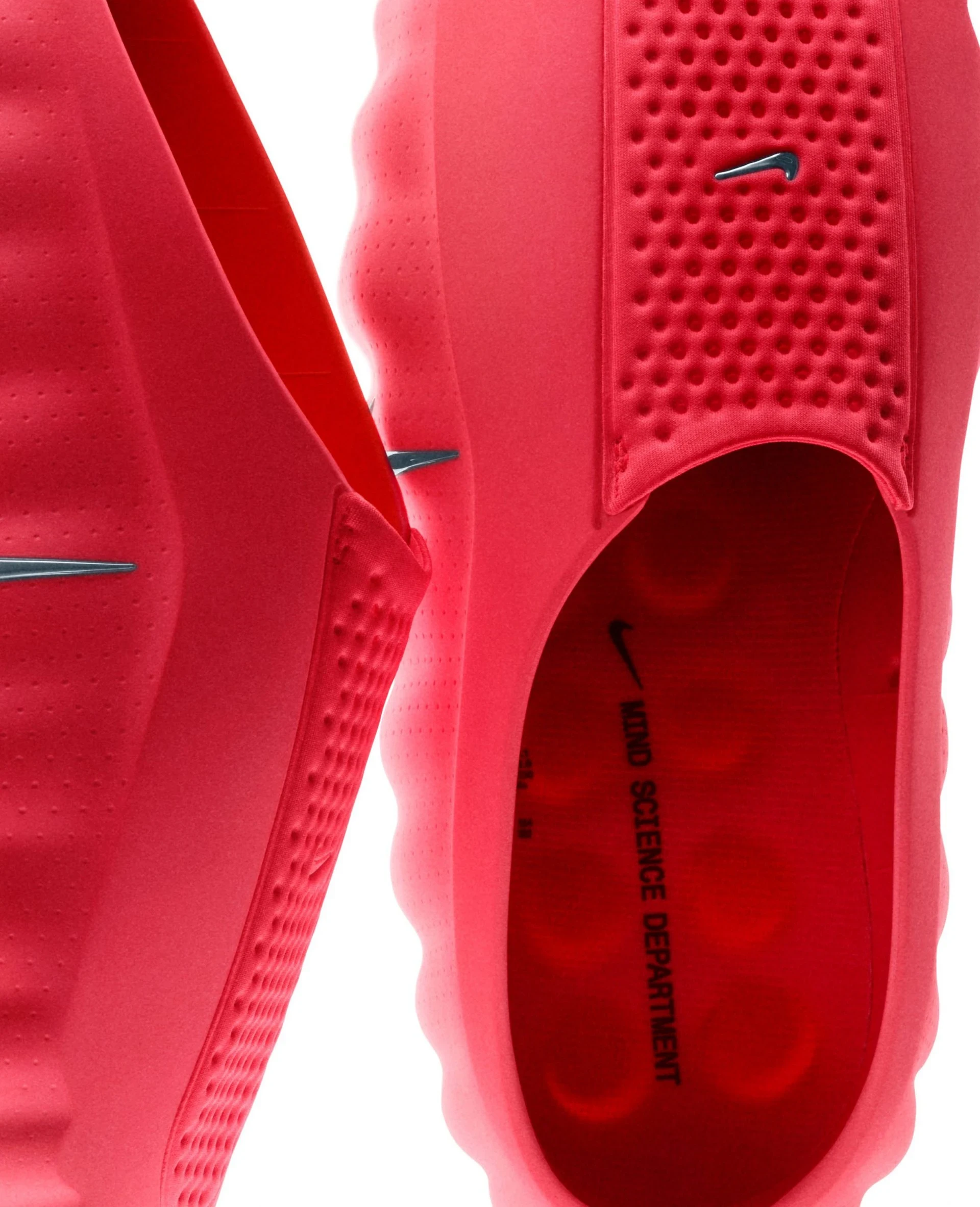 Nike Mind 001 + 002 — Close-up detail of Nike Mind 001 footwear in hot pink fabric, revealing the shoe's construction through a sectional view.