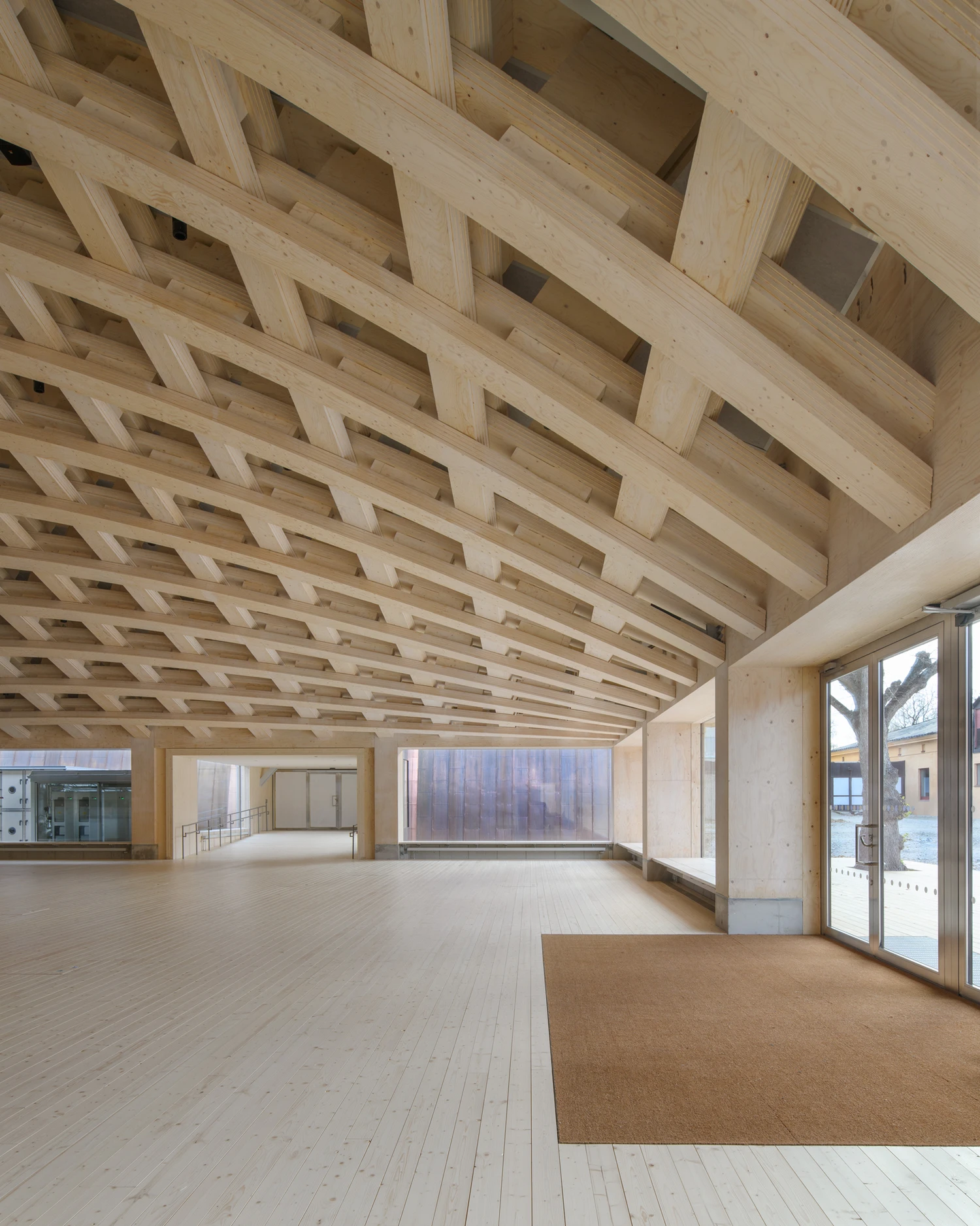 Wisdome Stockholm (National Museum of Science and Technology) by Elding Oscarson — Elding Oscarson's timber ceiling dominates this interior view of Wisdome Stockholm, a barrel vault constructed from laminated wood ribs with regularly...