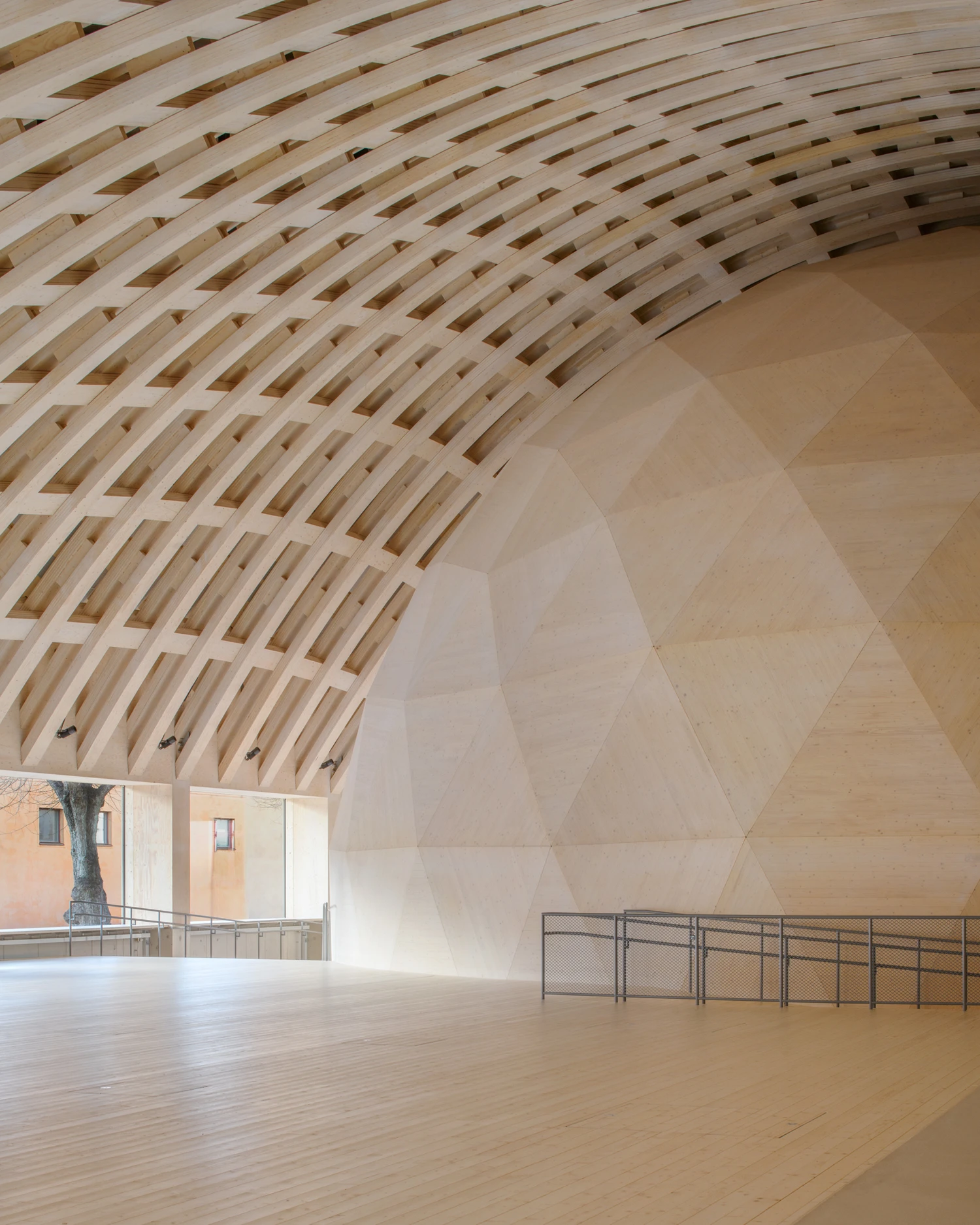 Wisdome Stockholm (National Museum of Science and Technology) by Elding Oscarson — The barrel-vaulted interior of Wisdome Stockholm's visualization dome, photographed from ground level looking toward the courtyard entrance.
