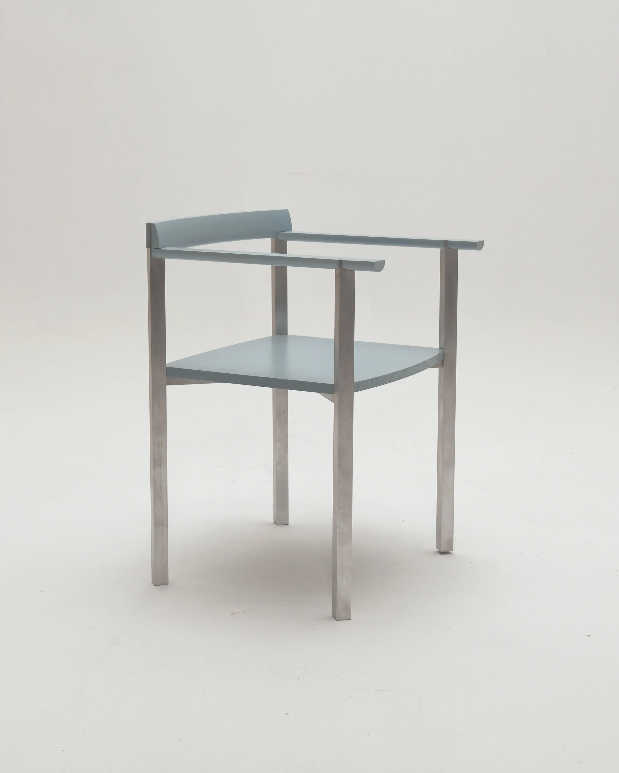 SQZY Chair by Timo Wuchner — The SQZY Chair presents a rectilinear frame in matte-finished metal with four tapered cylindrical legs that taper toward the floor.