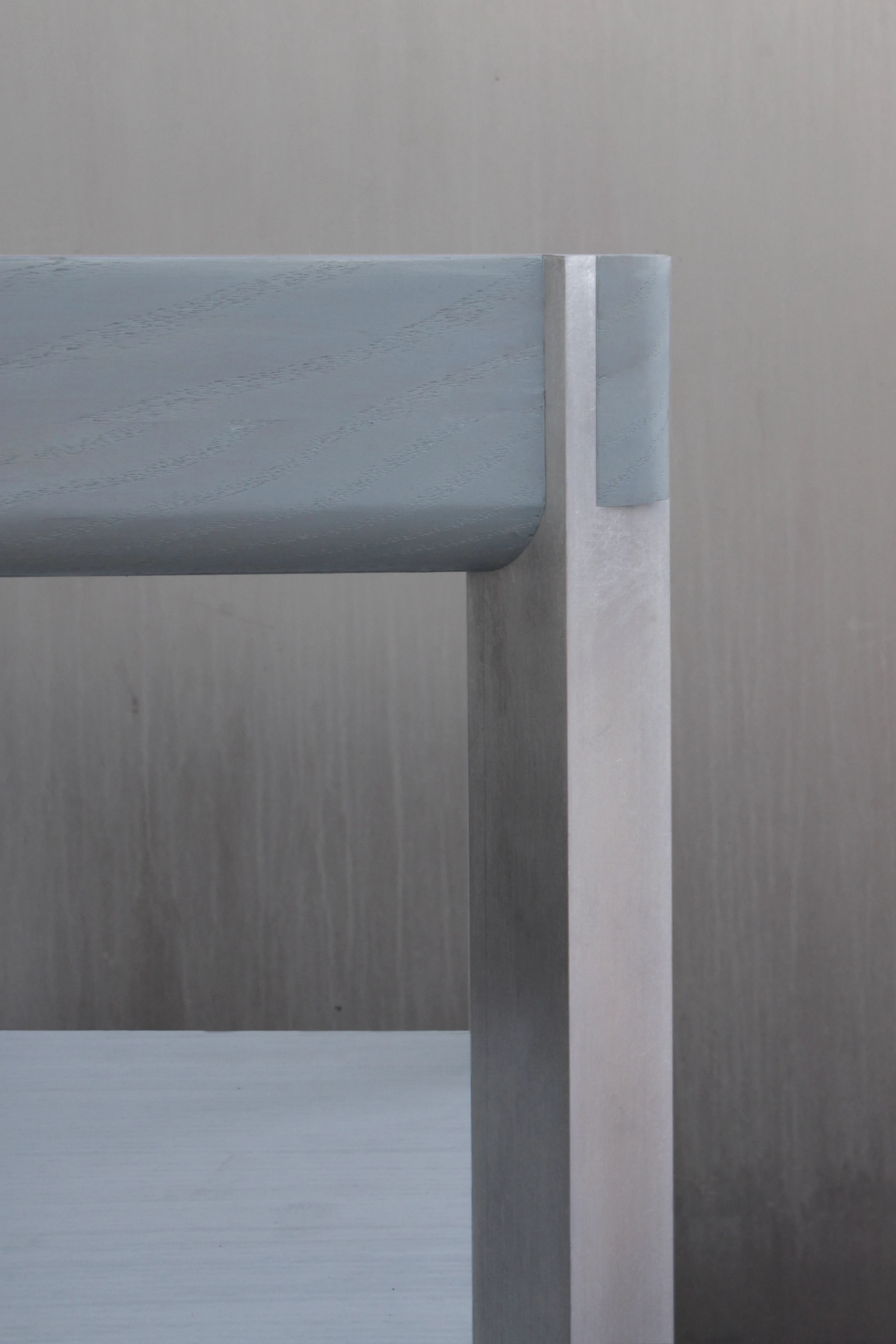 SQZY Chair by Timo Wuchner — Tight detail framing the SQZY Chair's joinery at the frame intersection where the backrest meets the vertical support post.