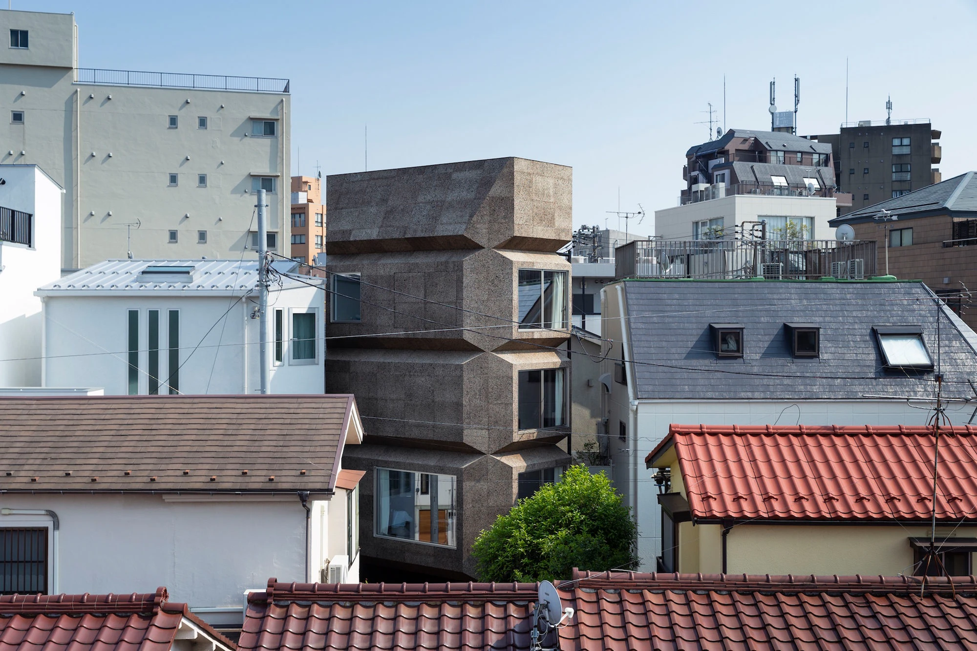 Bay Window Tower House by Takaaki Fuji + Yuko Fuji Architecture — The Bay Window Tower House rises prominently among Tokyo's dense residential fabric, its octagonal form and stacked bay window protrusions creating a...